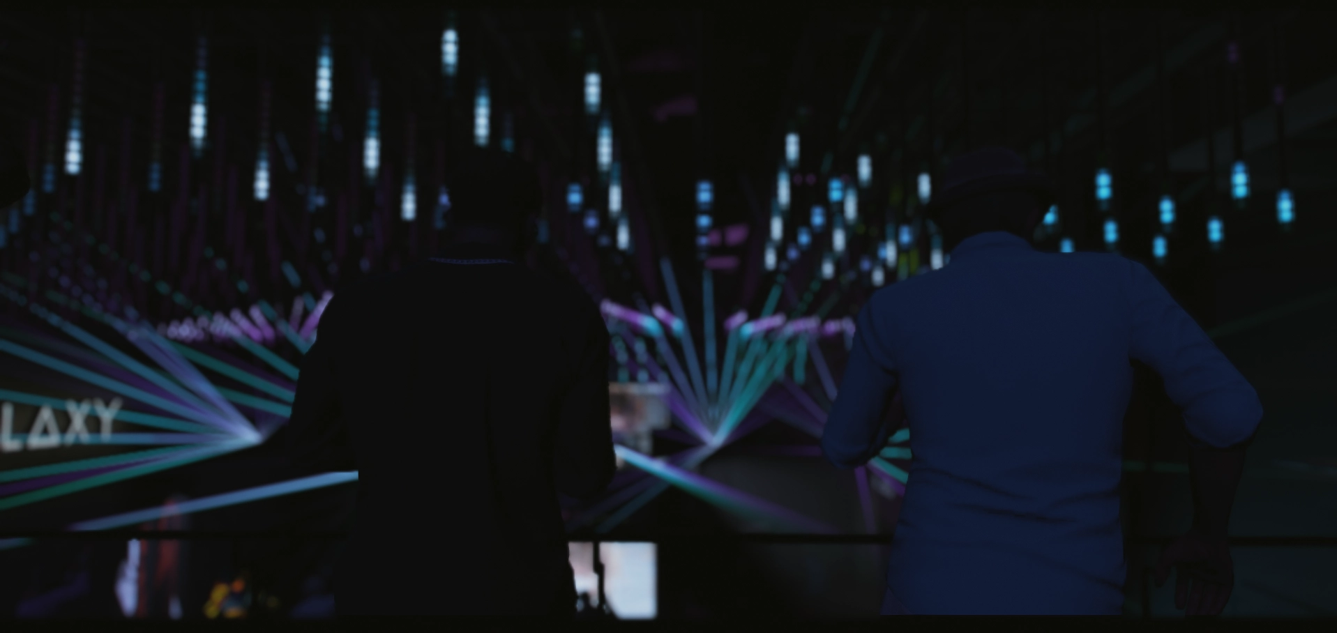 Two people at a club under laser lights