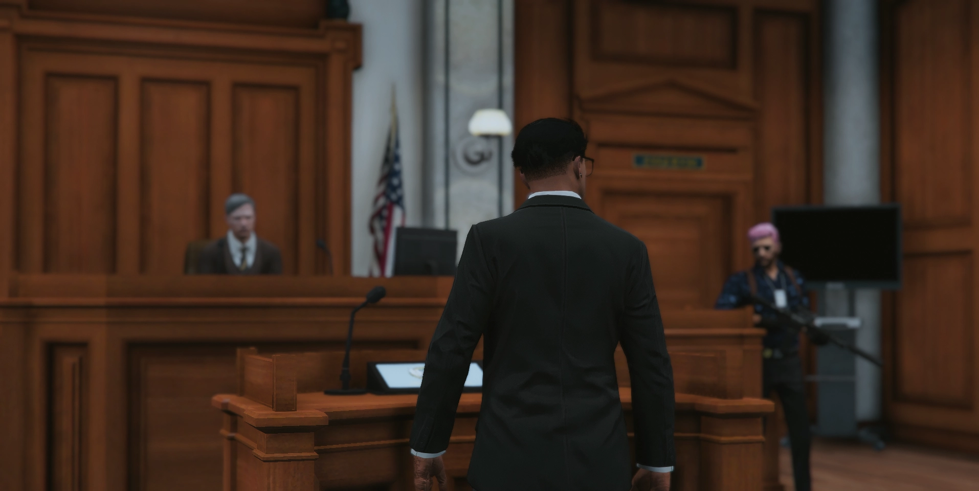 A suited man addressing a courtroom