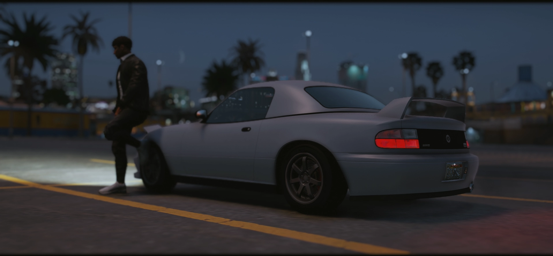 A car at dusk with the city skyline behind
