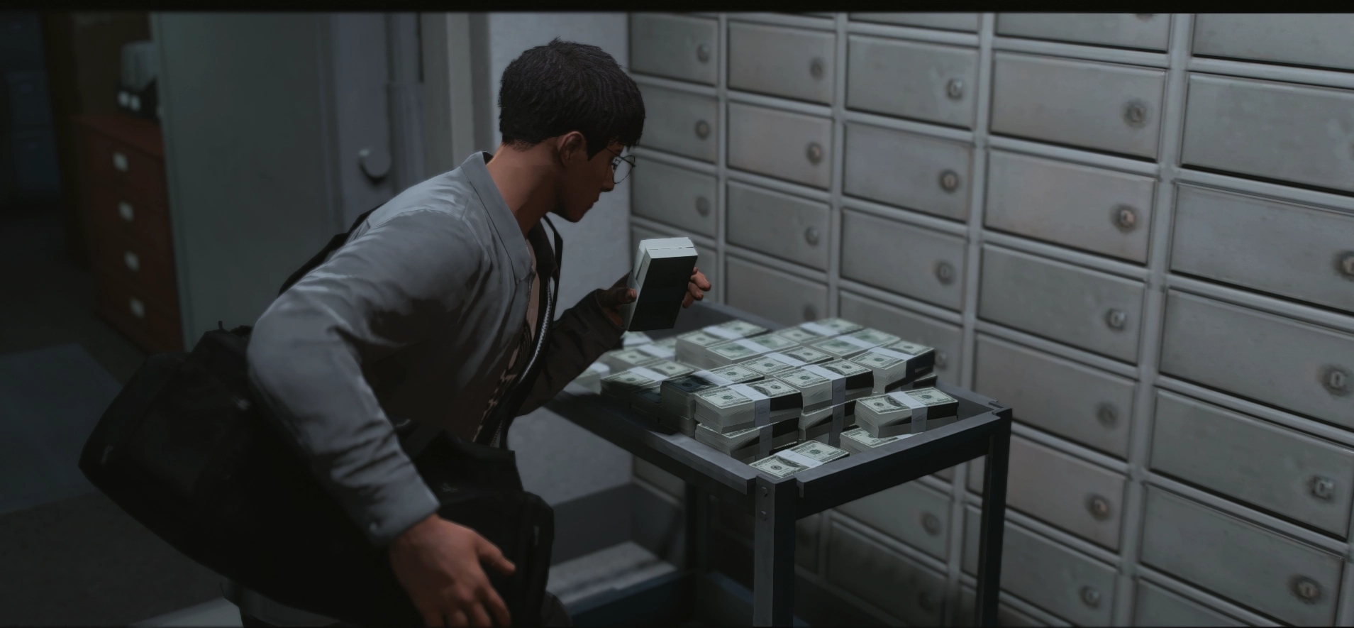 A robber bagging cash in a bank vault